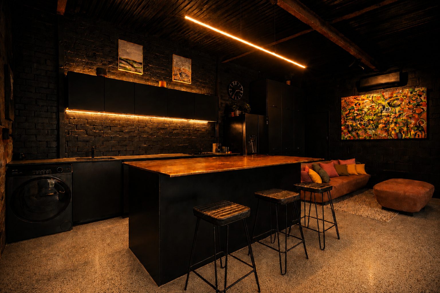 The Midnight Hideaway – black kitchen with copper island bench and warm LED lighting